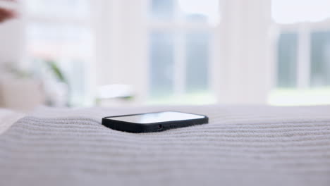 cama, alcanzando el teléfono y las manos de la persona
