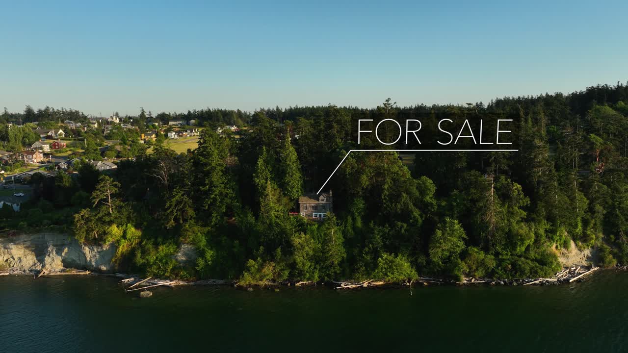 Aerial view of a waterfront home with an animated &amp;quot;FOR SALE&amp;quot; sign appearing over it