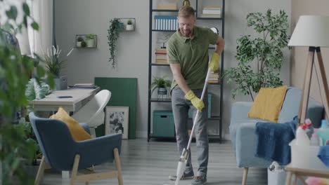 man mopping the living room