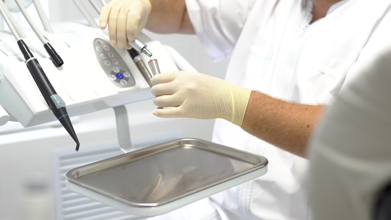 Dentist Adjusting Dental Equipment