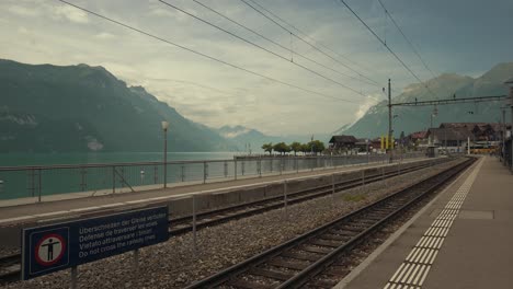 static shot of a train station beside an alpine lake near interlaken, switzerland
