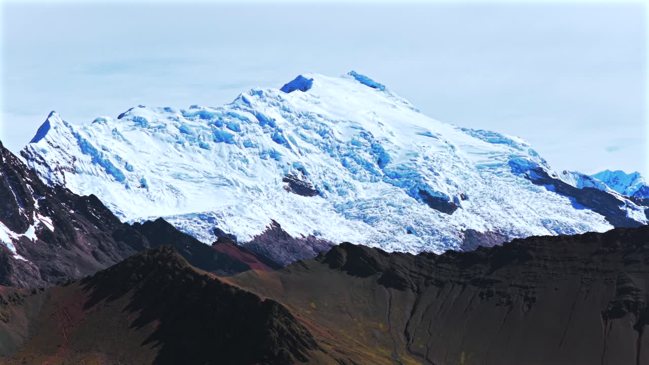 Peruvian Andes Ausangate Glacier Rainbow Mountain Vinicunca Peru Perú glacial Nevado Auzangate Vilcanota Cusco Region morning blue sky clouds Hatun Ritty rainy season parallax circle left motion