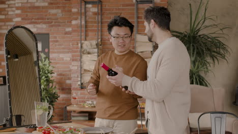 an young man and his friend talk about wine while holding a bottle