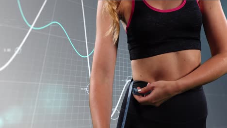 animation of midsection of fit caucasian woman with measure over graphs on grey background