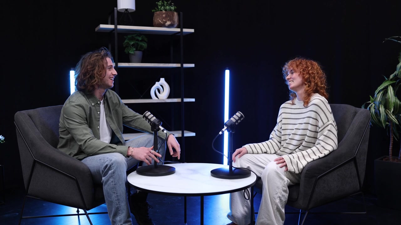 Young Man and Woman Talking During a Podcast Interview