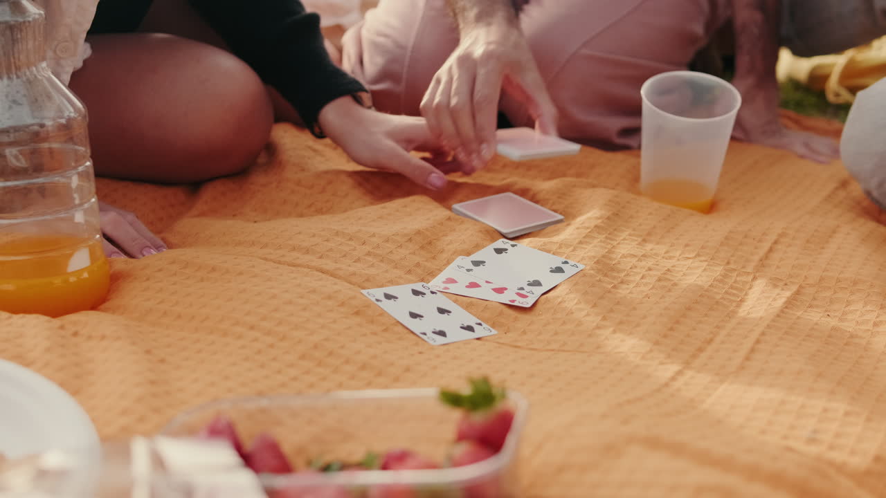 Friends Playing Cards at a Summer Picnic