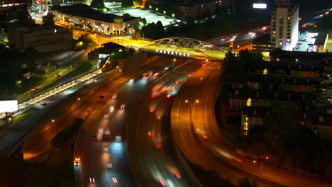 traffic on multilane freeway and road bridge spanning thoroughfare