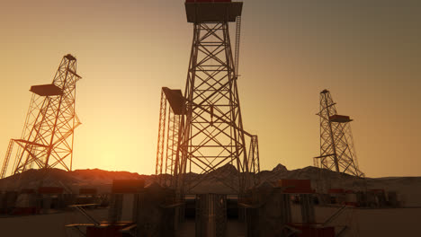 A-big-drill-rig-during-sunrise-on-the-oil-field.-A-metal-construction-used-in-the-petrochemical-industry.-Equipped-with-large-drills-the-structure-can-drill-oil-wells-or-natural-gas-extraction-wells.