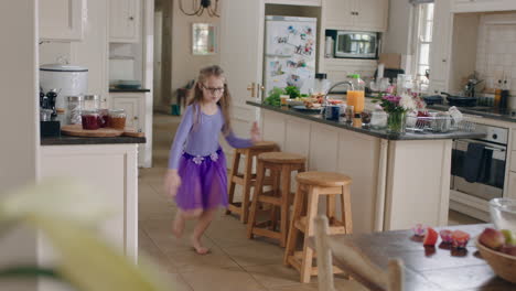 happy ballerina girl dancing in kitchen wearing purple tutu having fun performing funny dance moves enjoying weekend celebration at home