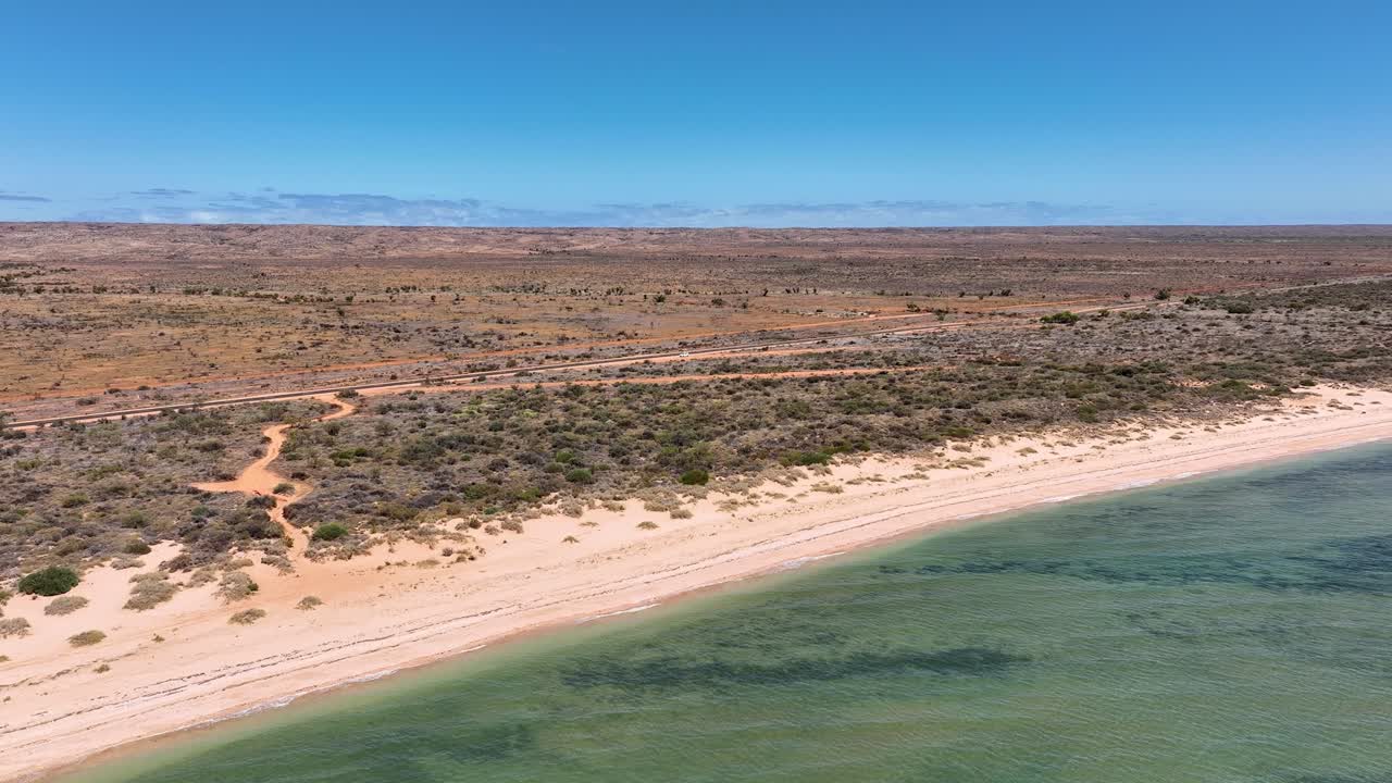 Capturing of a vacant beach with arid land at background in Exmounth, Australia. Drone view.