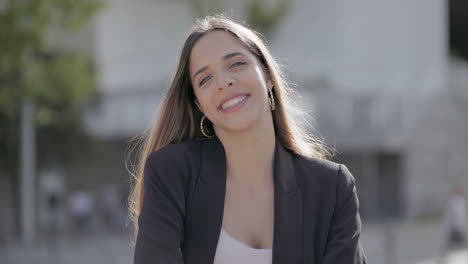 mujer joven feliz sonriendo a la cámara al aire libre