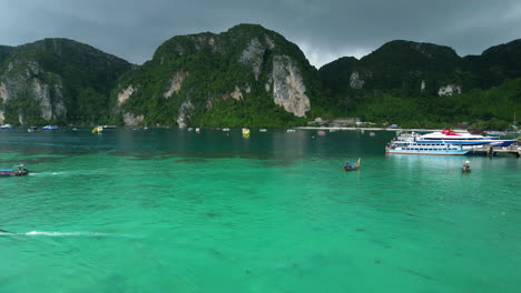 Tropical-landscape-and-boats-of-Phi-Phi-island-with-storm-clouds-flowing-above