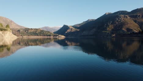 guejar river with calm water and huge rocky cliffs in its banks on a sunny day