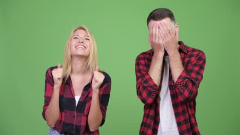 Young woman looking excited with young man having headache together