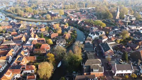 The-lovely-village-of-Winsum,-Groningen-from-above,-with-its-bendy-canal-and-windmills