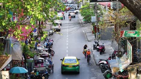 vehicles and pedestrians navigating a busy city crossroad.