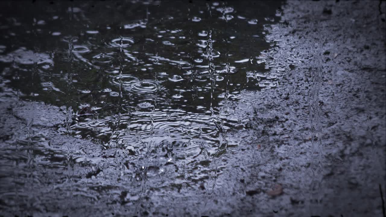 Heavy rain shower downpour cloudburst rainfall behind the glass.