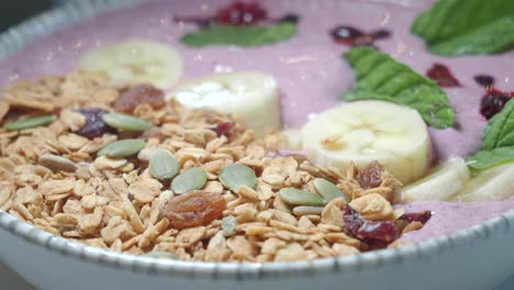 smoothie bowl with granola, banana, and mint