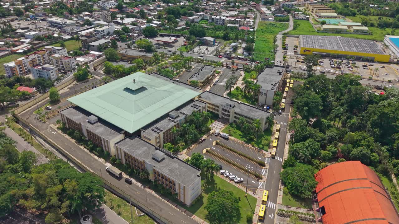 Campus of the Autonomous University of Santo Domingo (UASD) in Bonao, Dominican Republic. Aerial top down. Orbit shot. Rooftop of modern buildings facility