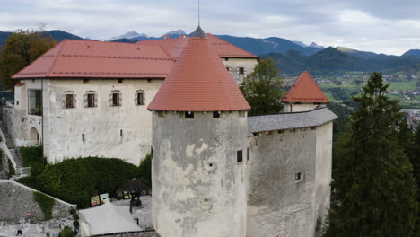 bled castle on hill in slovenia - drone shot