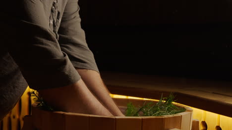 preparing a traditional sauna with fir branches