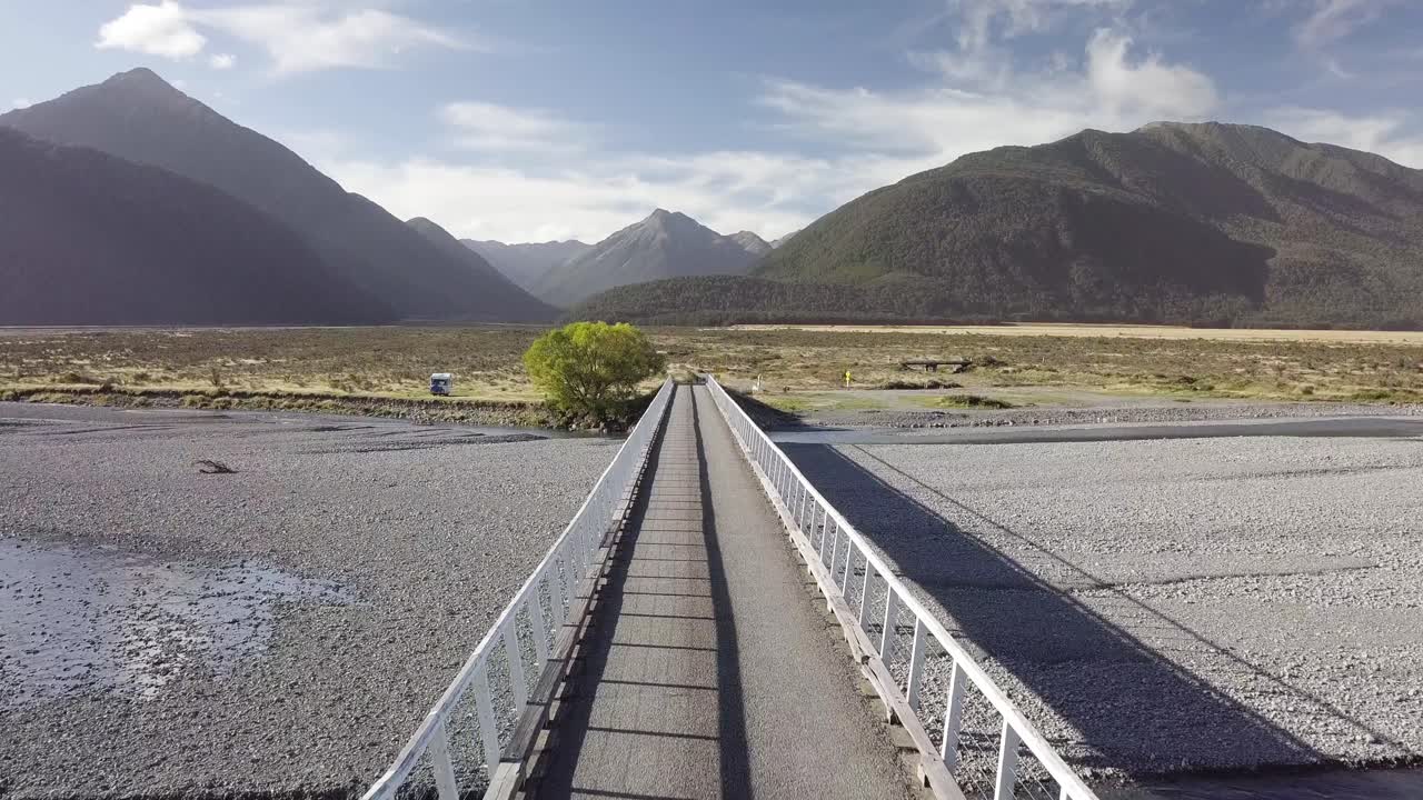 Drone flight over Mt White Bridge and Waimakariri River, Canterbury New Zealand. Beautiful view of Mt. Temple and Gray Hill.