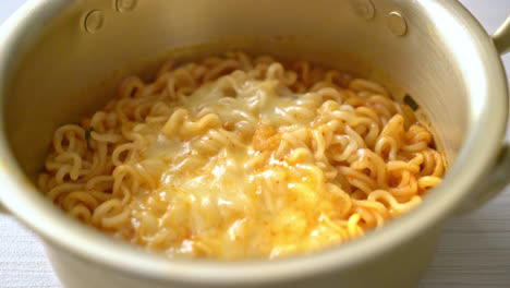 korean spicy instant noodle bowl with mozzarella cheese