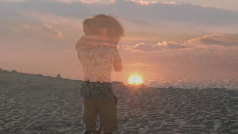 animation of romantic african american couple hugging at beach over sunset