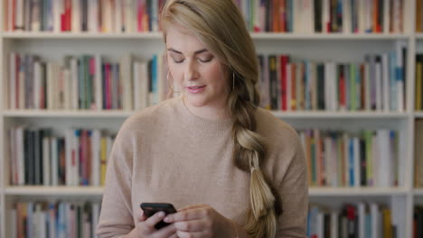 portrait beautiful blonde woman entrepreneur using smartphone enjoying browsing online social media messages young female student sending sms in library bookstore slow motion