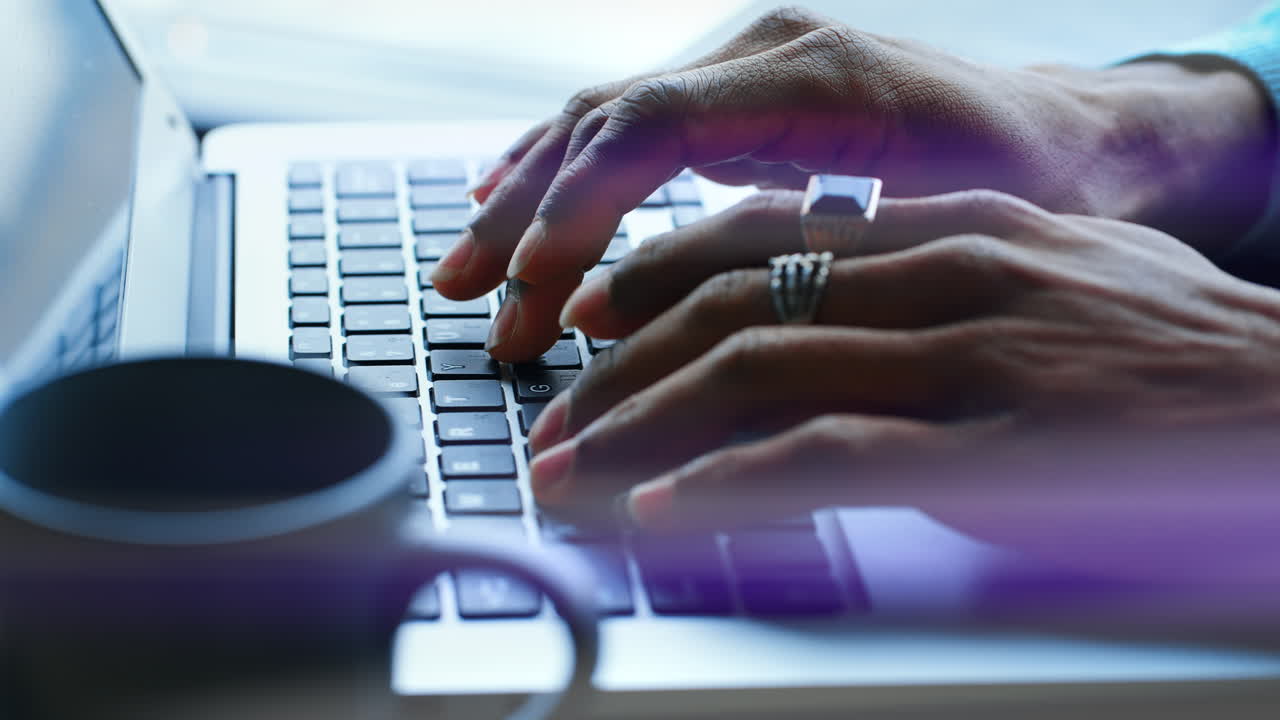 Close-Up of Hands Typing on Laptop Keyboard