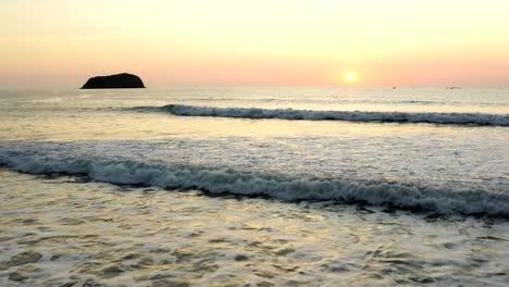 panoramic shot of beach and waves at sunset