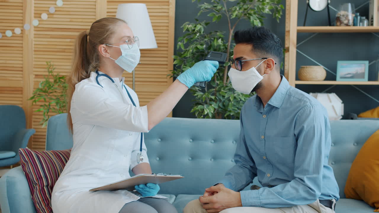 Doctor checking patient's temperature