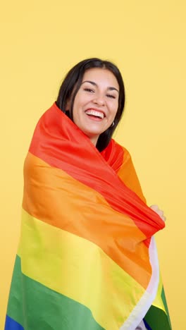 happy woman wrapped in rainbow pride flag
