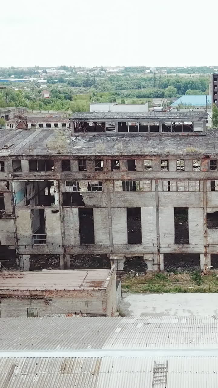 Ruins of an old factory. Old industrial building for demolition. Aerial view. Vertical video