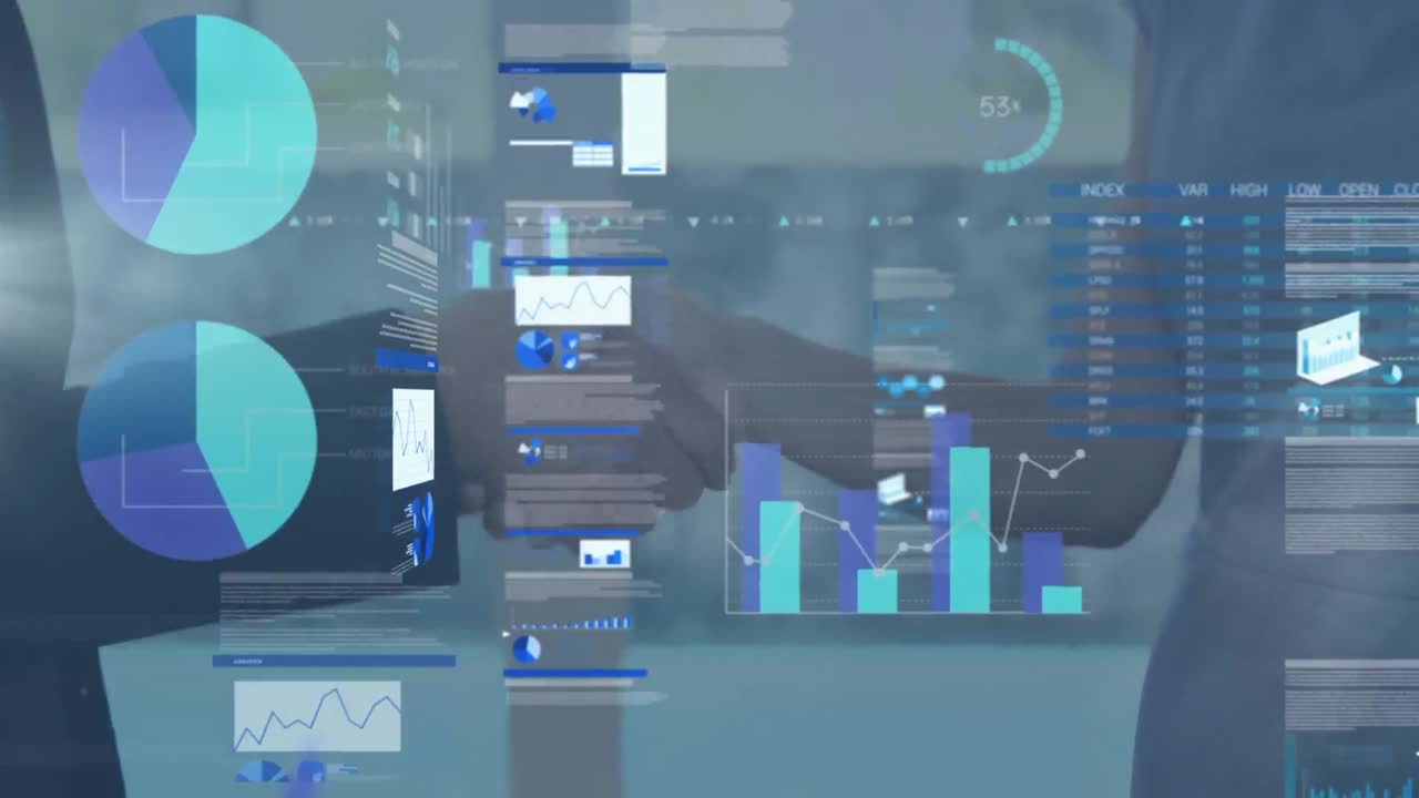 Screens with data processing against over mid section of businessman and businesswoman shaking hands