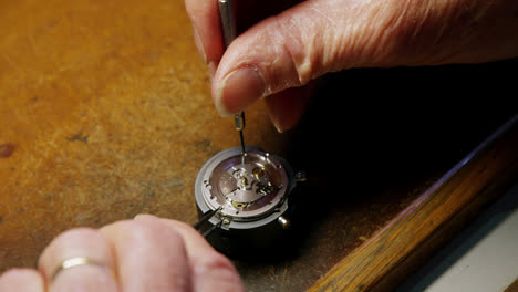 close-up of horologist repairing a watch