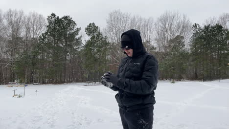 pov shot of teenager throwing a snowball directly at the camera