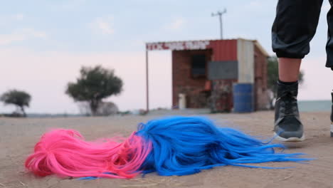 Two-women-dropping-their-wigs-on-the-ground