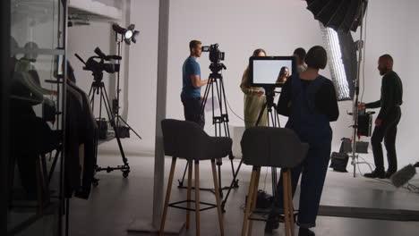 actores ensayando con el director filmando película o video en el estudio con equipo de sonido y cámara