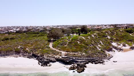 The-tide-comes-in-and-above-the-boardwalk-of-the-Ocean-Reef,-Australia