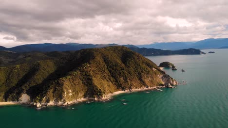 Abel-Tasman-coast-scenery,-golden-hour-light-aerial-birds-eye-shot