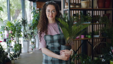 friendly florist holding a palm plant
