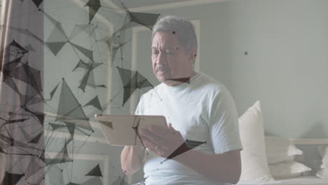 animation of network of connections spinning over senior man using tablet at home