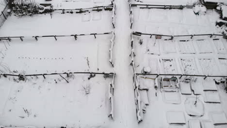 aerial view of community farm with paddocks in white snow on a winter day