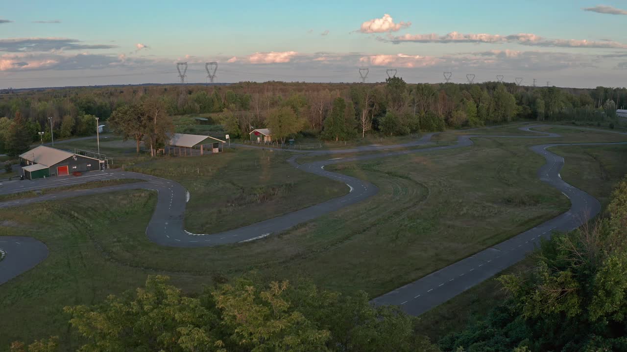 Abandoned go-kart race track at sunset, shot by drone