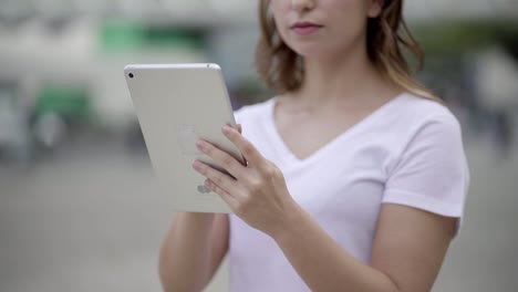 cropped shot of young woman using tablet