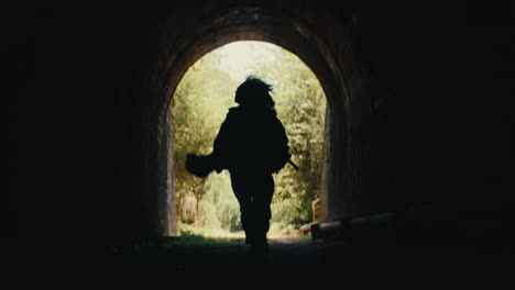 person running through a tunnel