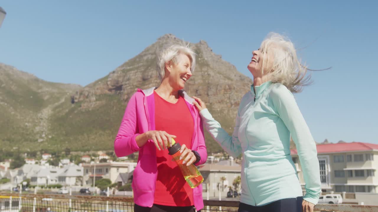 Athletic women discussing on the beach