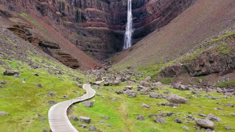 photographer walking to a waterfall