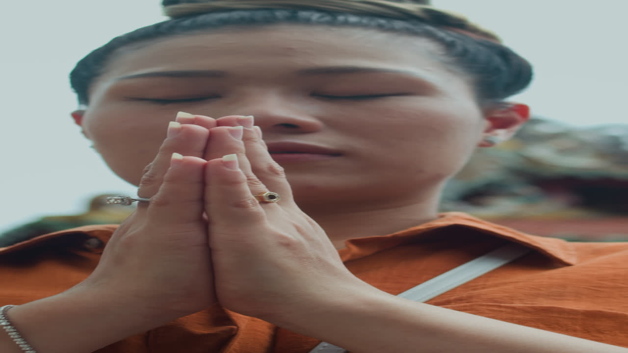 Woman Praying during Meditation on Territory of Temple
